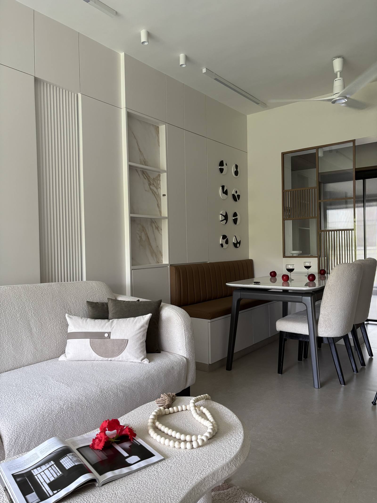 Open-plan living and dining room with fluted panel wall designed by Beyond Briks