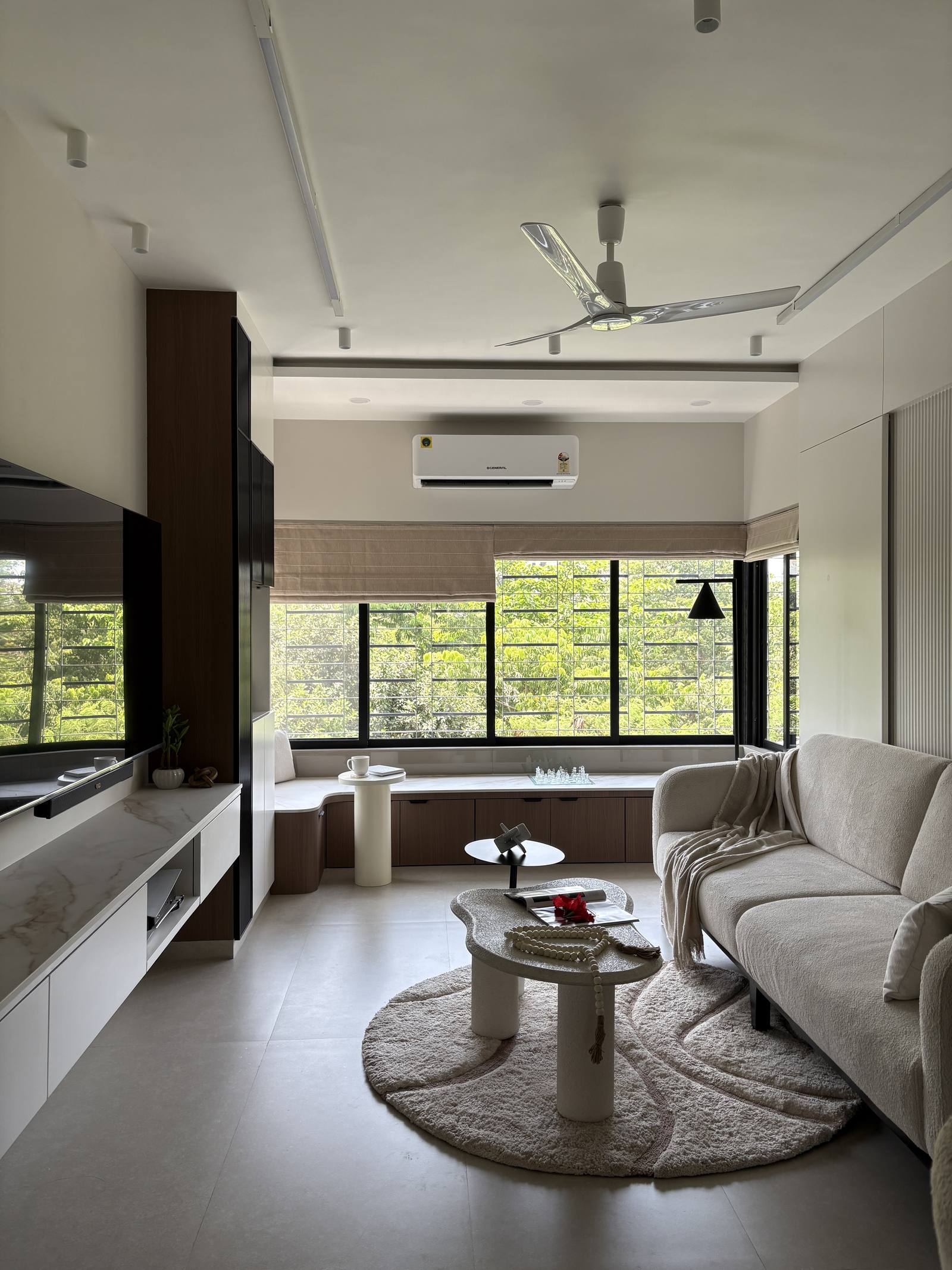 Residential living room with floor-to-ceiling windows designed by Beyond Briks