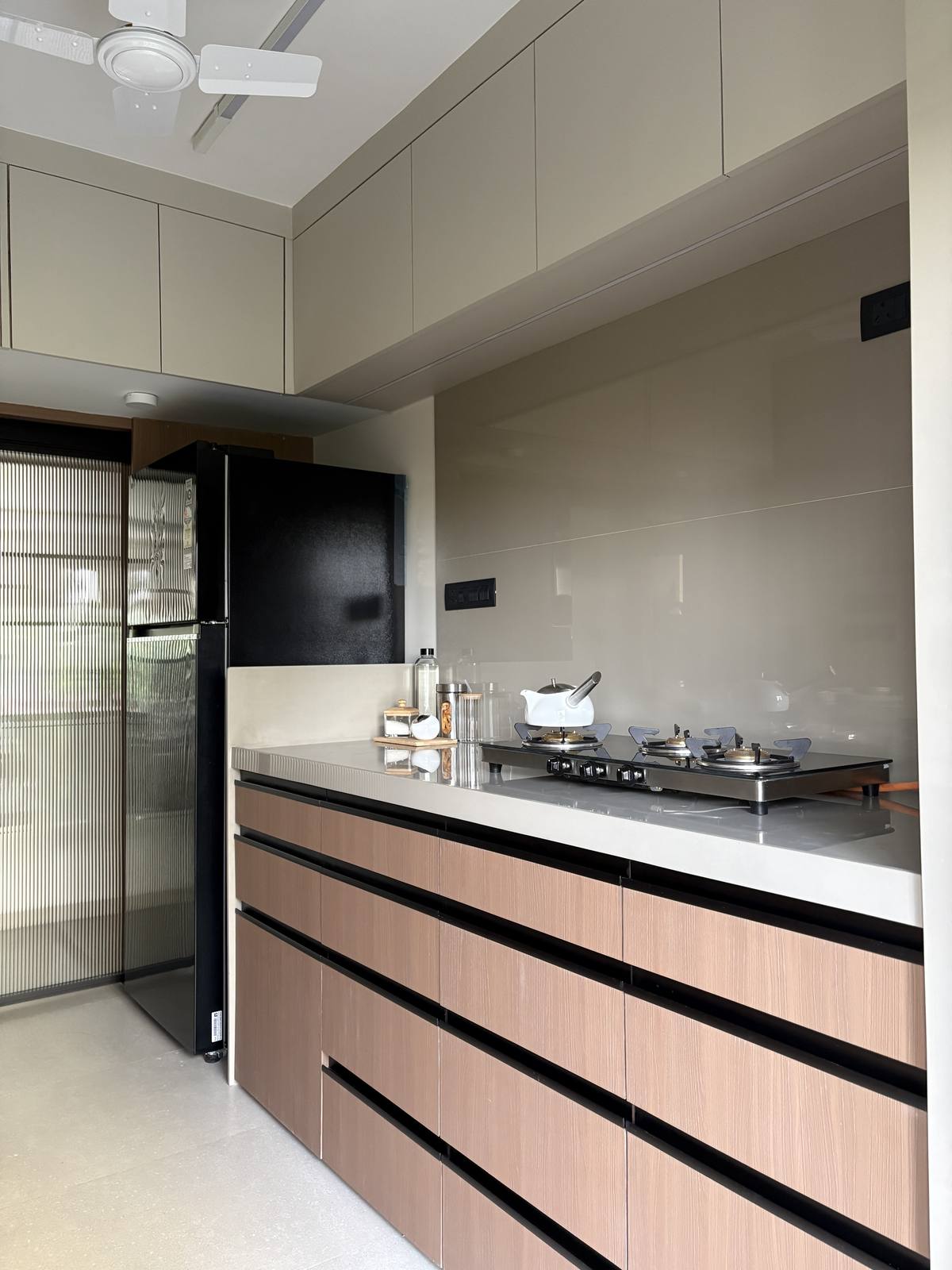 Modular kitchen counter with sleek cabinetry by Beyond Briks