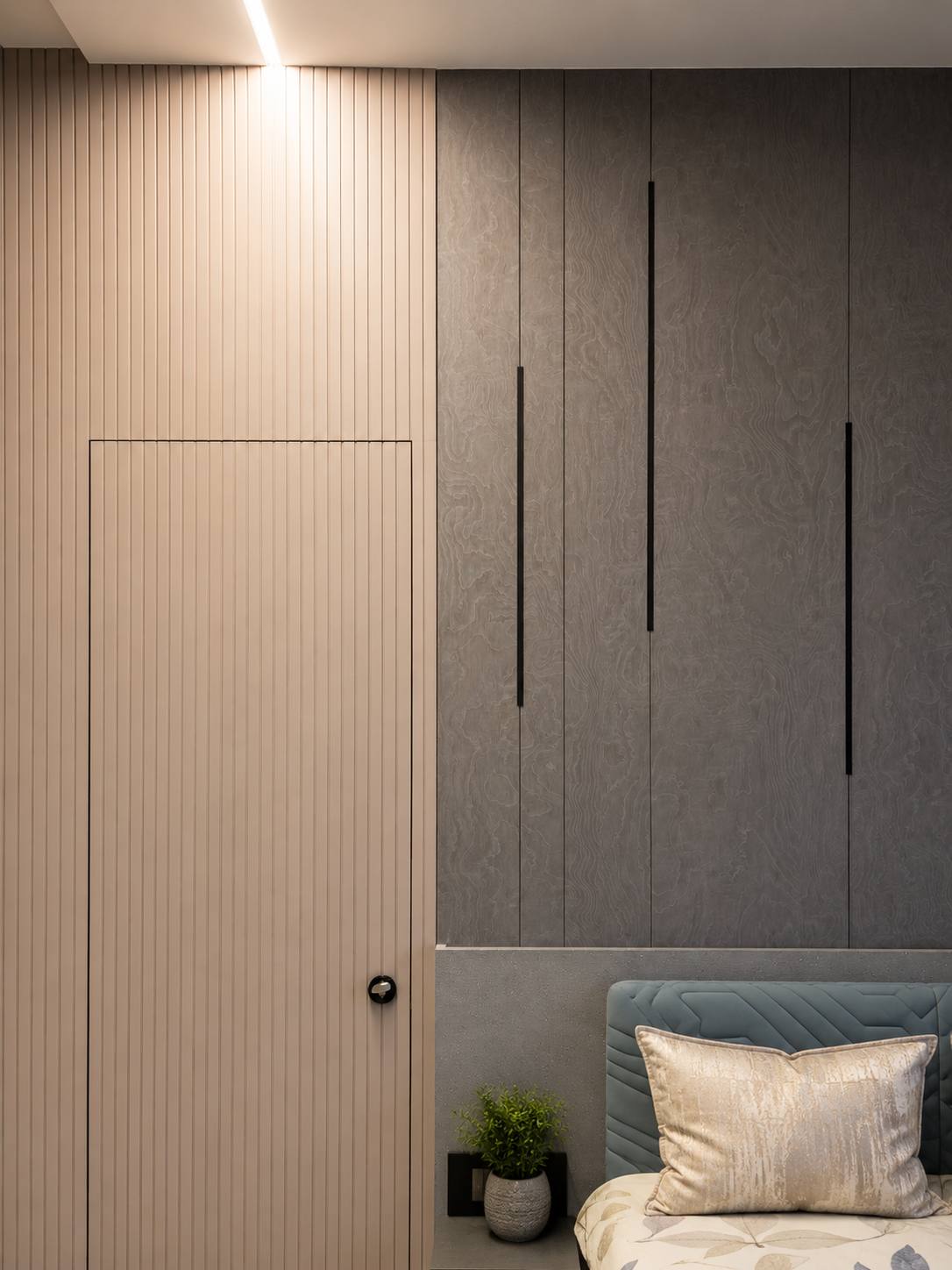 Fluted-panel walk-in wardrobe with brass handles by Beyond Briks
