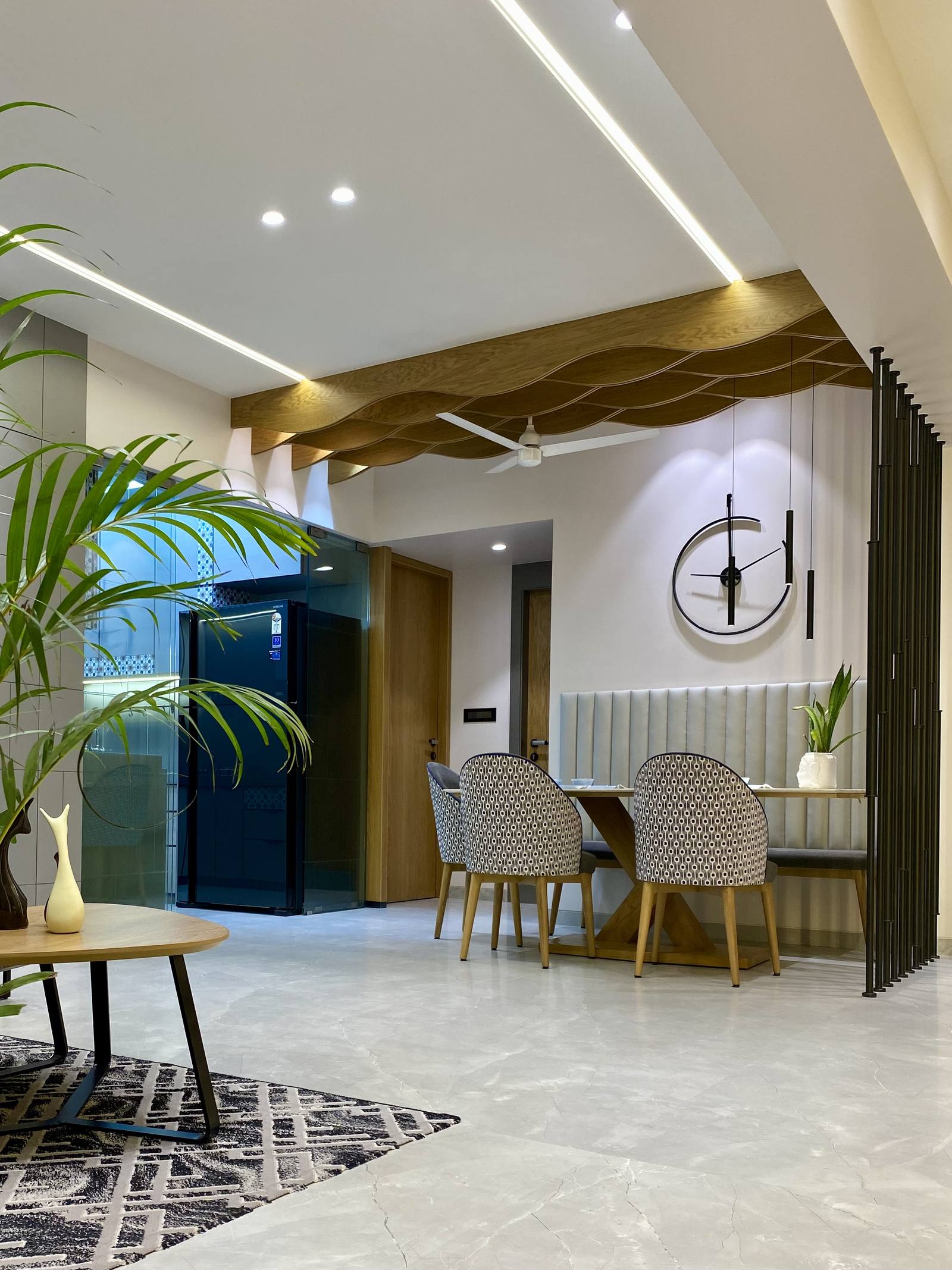 Sculptural wave false ceiling in a luxury living and dining space by Beyond Briks