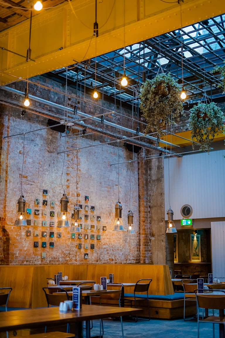 Industrial restaurant interior design style with exposed brick and Edison lighting